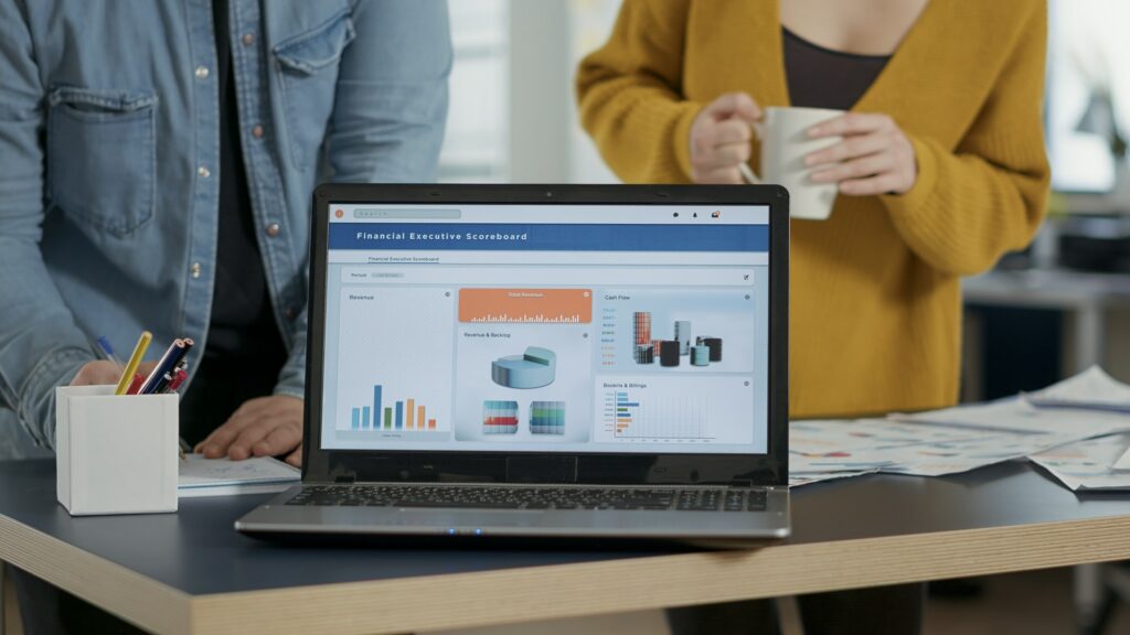 Closeup of laptop screen with business mangement software showing moving charts and statistics