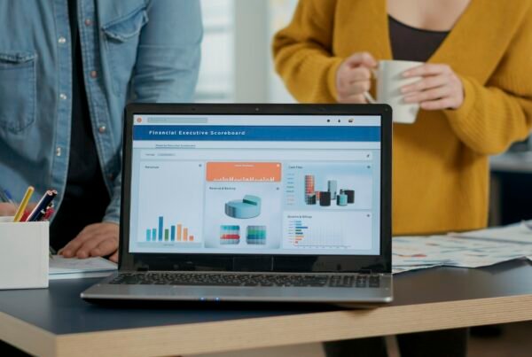 Closeup of laptop screen with business mangement software showing moving charts and statistics