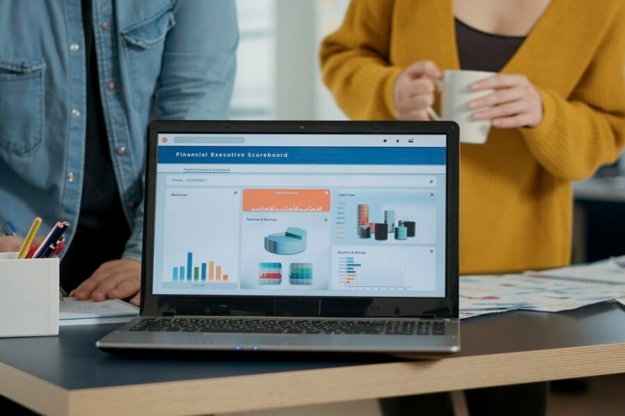 Closeup of laptop screen with business mangement software showing moving charts and statistics