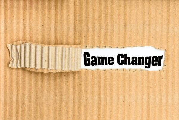 Game Changer, word written on a torn piece of cardboard.