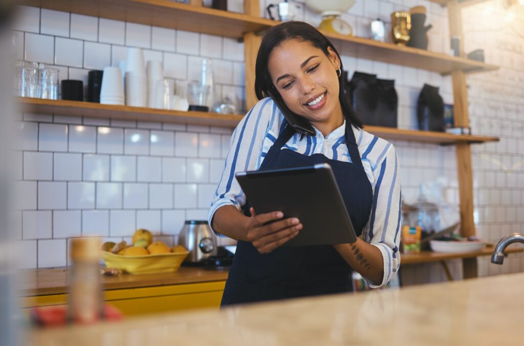 Restaurant worker on a tablet, phone call and making food payment, delivery or crm conversation wit