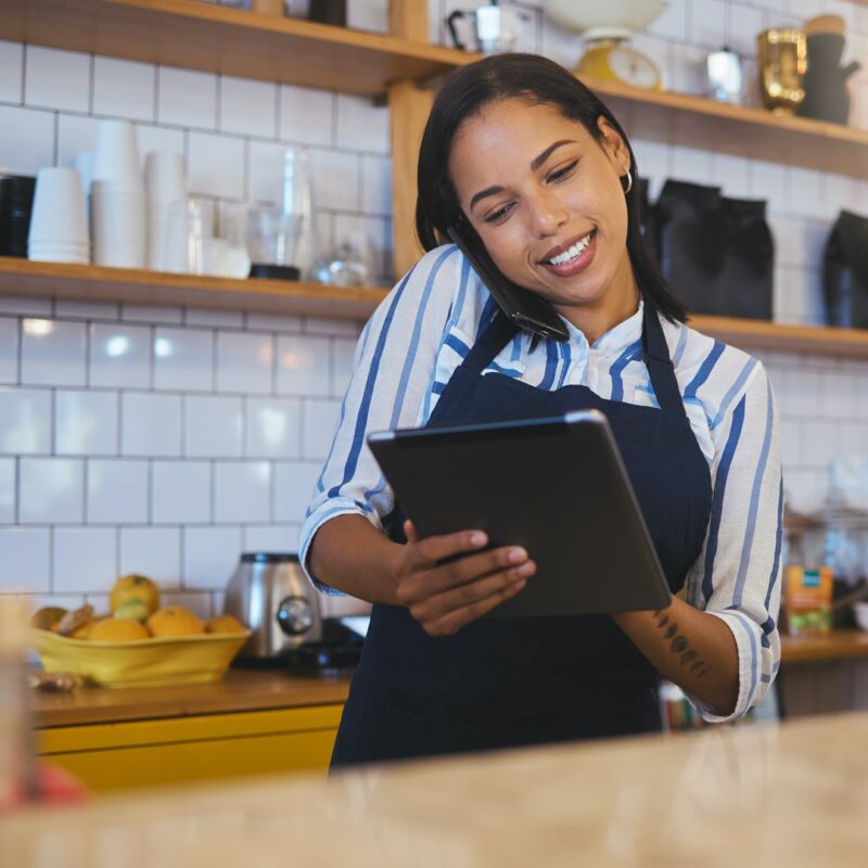 Restaurant worker on a tablet, phone call and making food payment, delivery or crm conversation wit