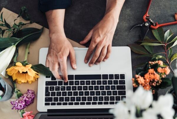 Young male florist working in flower shop